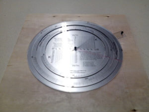 Circular slide-ruler in acrylic on plywood board.